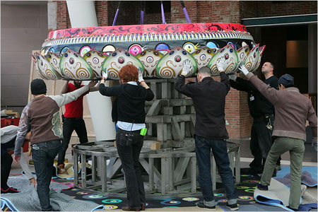 Workers assemble Mr. Pointy, a large-scale sculpture by Takashi Murakami